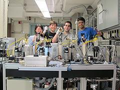 students standing in front of scientific machines